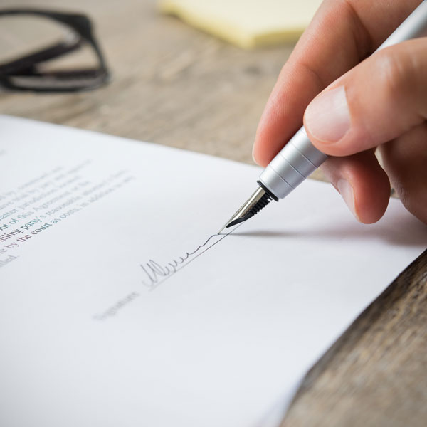 man signing paperwork
